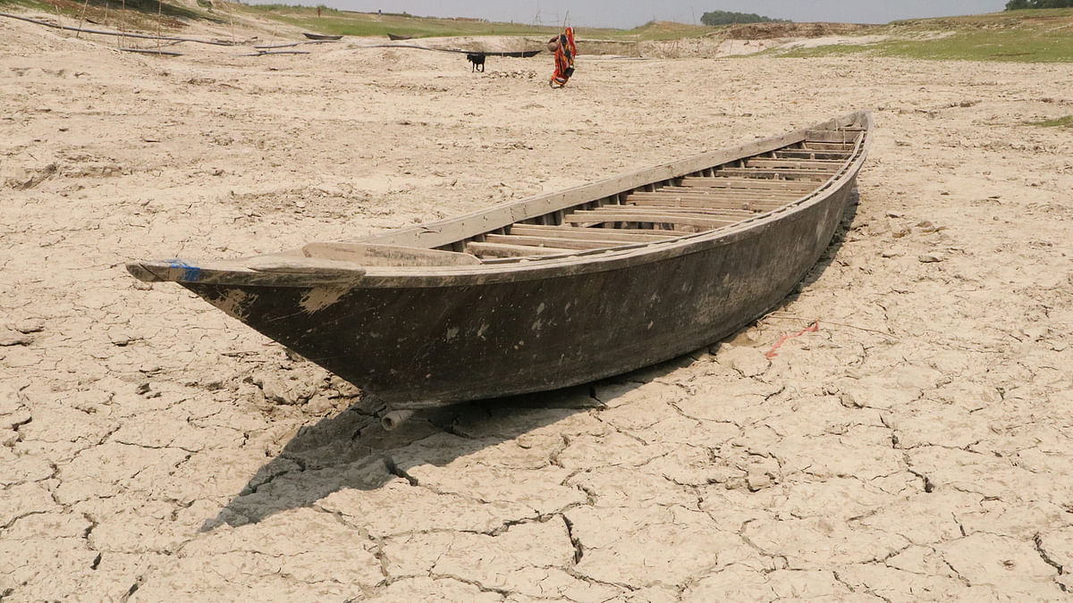 A boat lies on the dried up part of the river Padma in Char Barart area of Rajbari. 21 March. Photo: Rashedul Haque