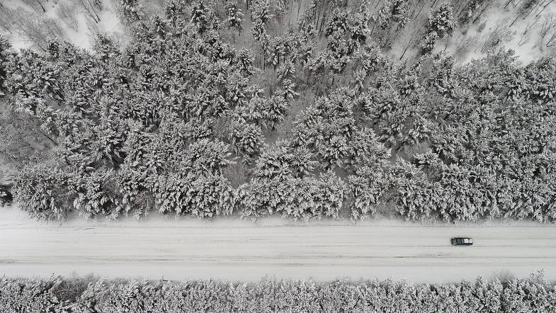 An aerial view shows a car driving along a forest road after snowfall outside Krasnoyarsk, Russia on 22 March 2018. Reuters
