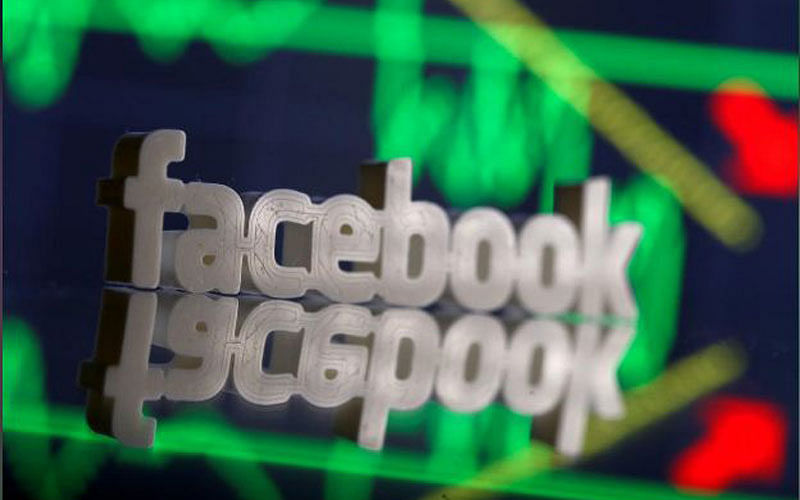 A 3D-printed Facebook logo is seen in front of displayed stock graph in this illustration photo, March 20, 2018. Reuters