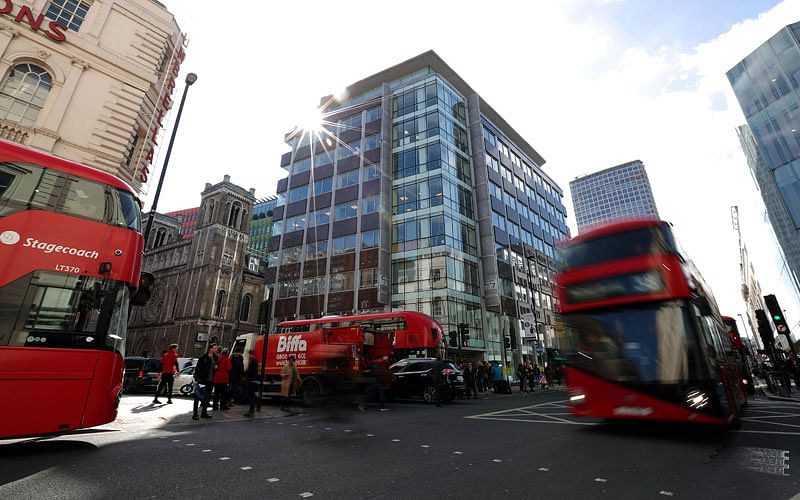 In this file photo taken on 21 March 2018 Traffic, including red London busses, passes the shared building which houses the offices of Cambridge Analytica in central London. AFP