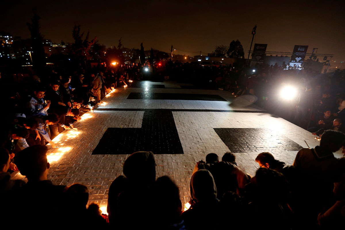 People light candles after they set a Guinness World Record by creating the world`s largest candle mosaic made of 11,440 candles form the number 60 to mark Earth Hour, at Amman Citadel, Jordan on 24 March 2018. Reuters