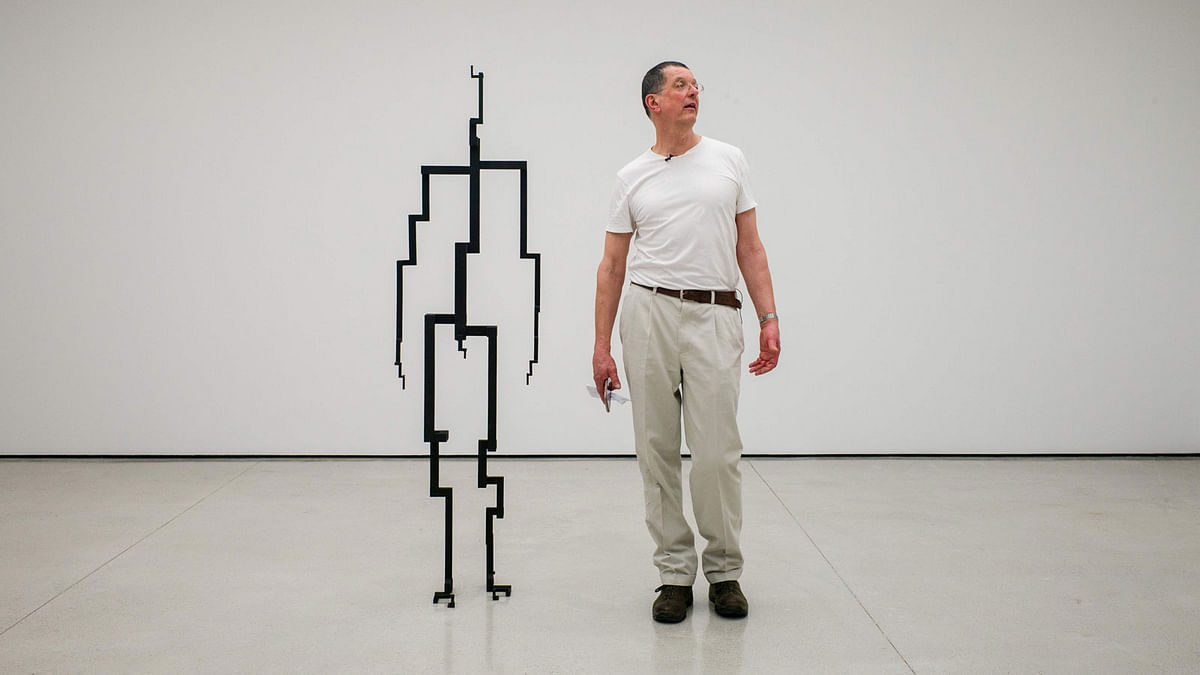 In this photo taken on 26 March 2018, British sculptor Antony Gormley stands next to his sculpture `Signal`, 2017, in his exhibition `Rooting the Synapse` at the White Cube gallery in Hong Kong. AFP