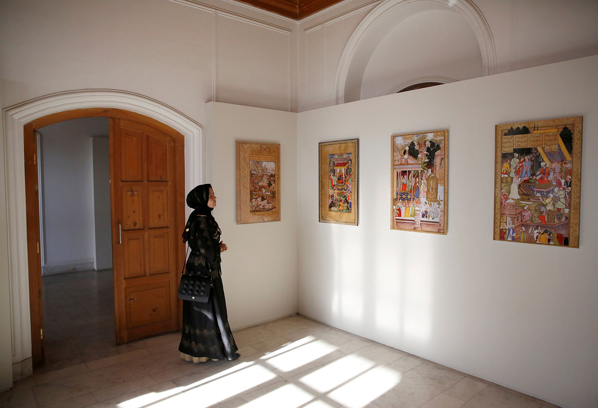 An Afghan woman looks at art exhibition at Babur Garden in Kabul, Afghanistan on 31 March 2018. Reuters