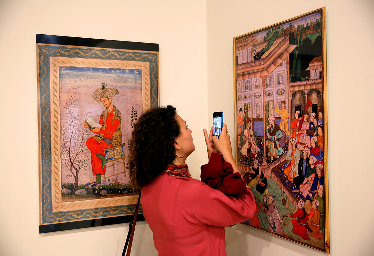 Woman takes photo at art exhibition at Babur Garden in Kabul, Afghanistan on 31 March 2018. Reuters