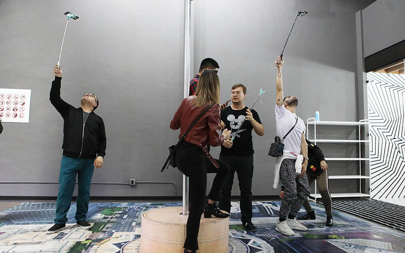 People take selfies on opening day at the Museum of Selfies on 1 April 2018 in Glendale, California. AFP