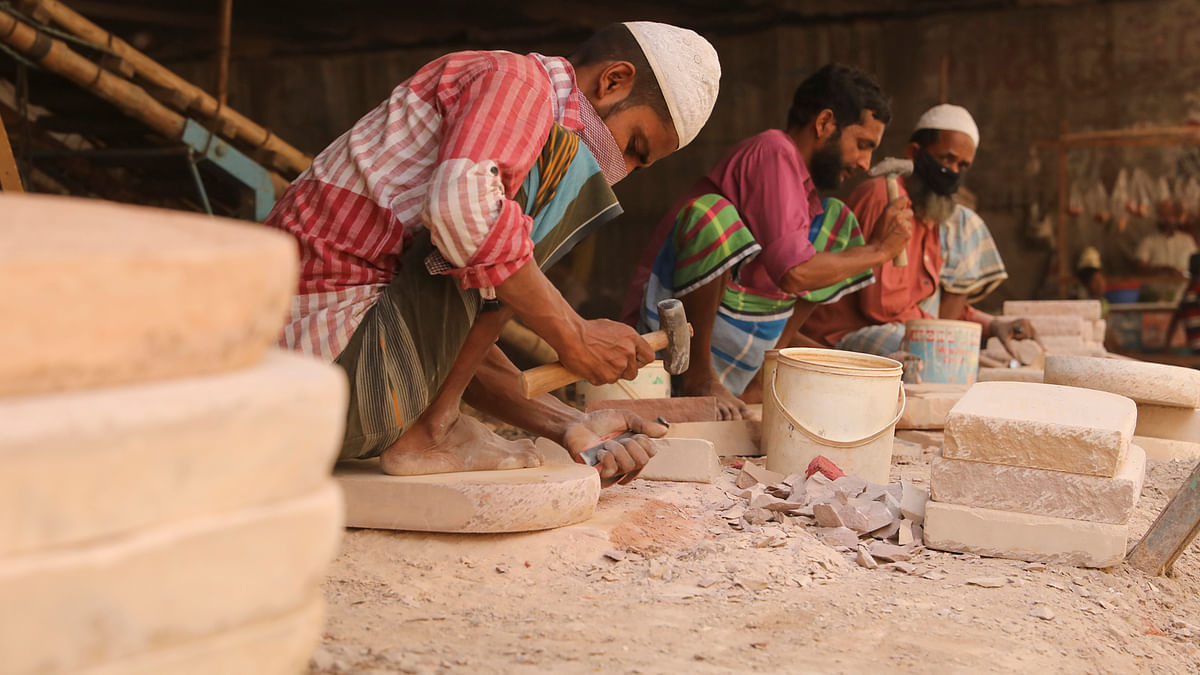 Workers are busy making stone grinder in Imambari of south Keraniganj on 1 April. Photo: Tanvir Ahmed