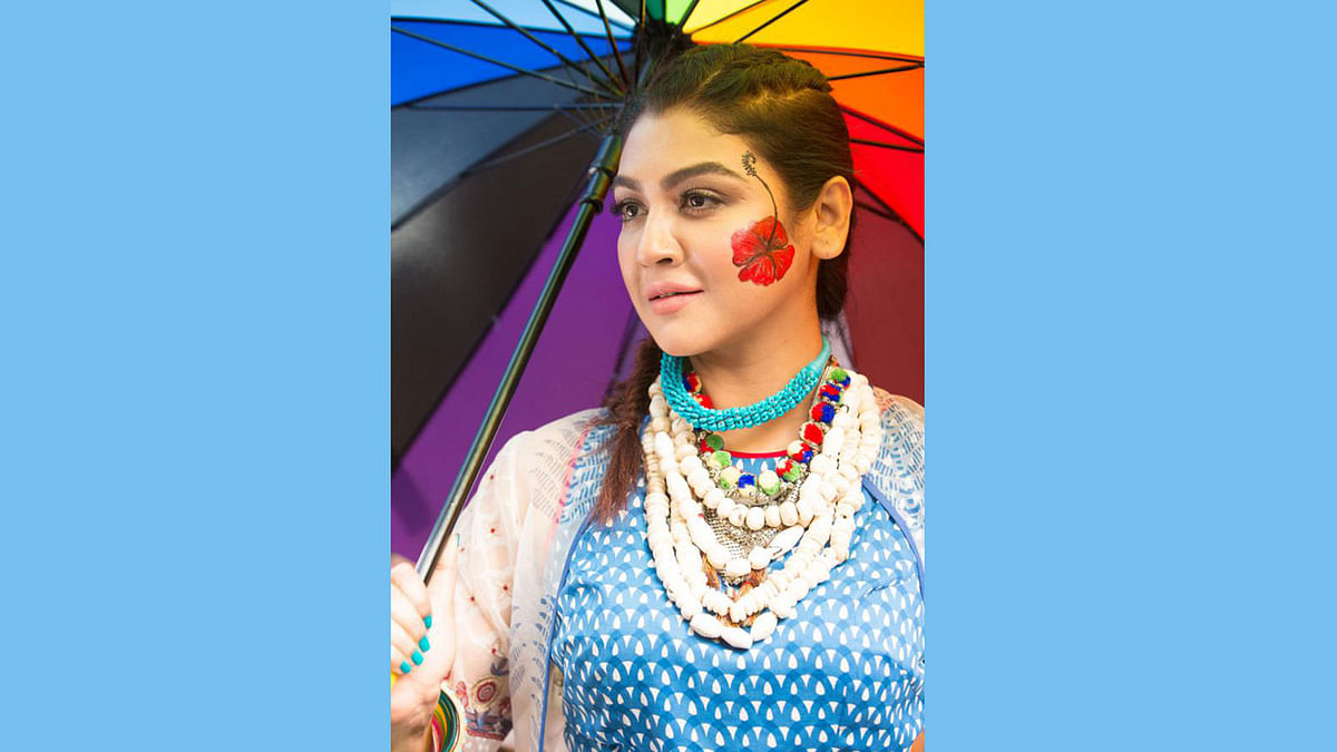 Hibiscus motif on the cheek and chunky necklaces round the neck. Photo: Photo: Kabir Hossain