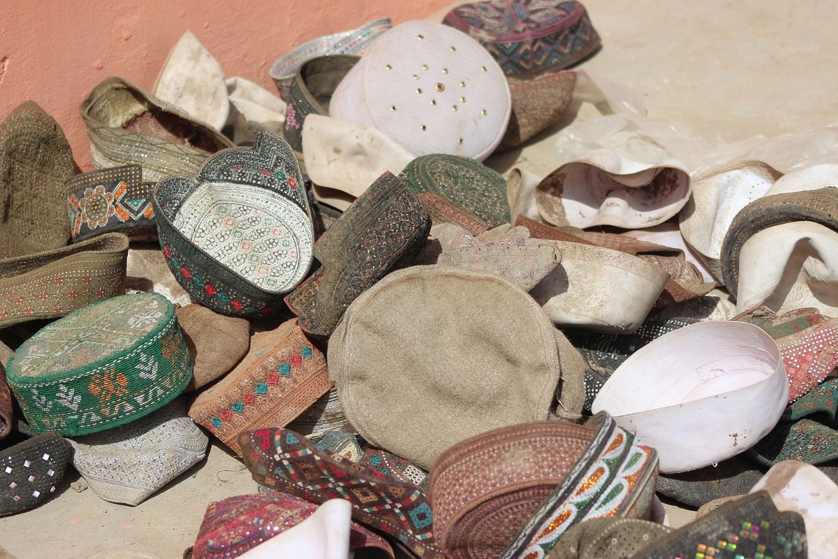 This photograph taken on 4 April, 2018 shows caps that were said to belong to victims of an airstrike at a religious school in the Taliban-controlled Dasht-e Archi district in Kunduz province. Photo: AFP