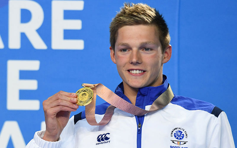 Scotland`s Duncan Scott (gold) poses with his medals after the swimming men`s 100m freestyle final during the 2018 Gold Coast Commonwealth Games at the Optus Aquatic Centre in the Gold Coast on 8 April, 2018. Photo: AFP