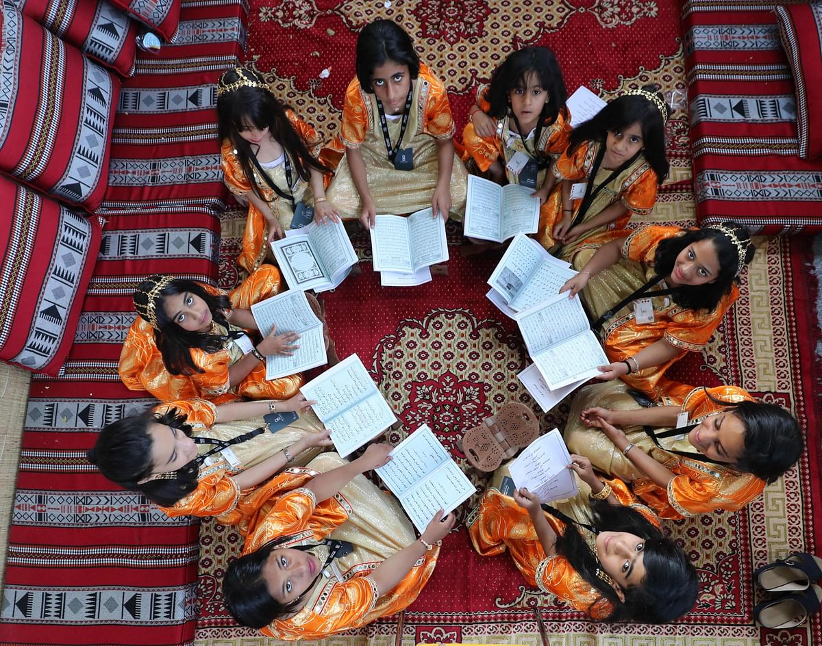 Emirati girls attend a class at a traditional school during the Sharjah Heritage Days festival 8 April 2018, at the Heritage Area in the United Arab Emirate. AFP