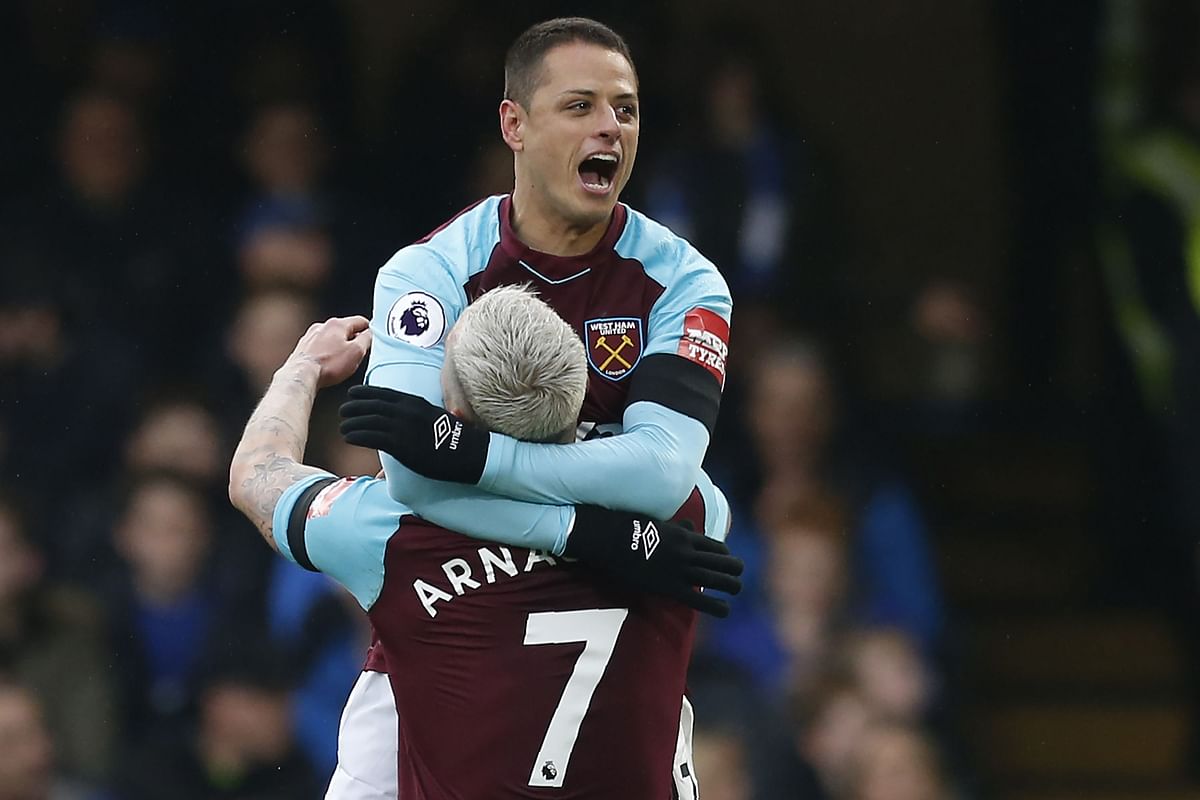 West Ham United's Mexican striker Javier Hernandez (R) celebrates with West Ham United's Austrian midfielder Marko Arnautovic after scoring their first goal during the English Premier League football match between Chelsea and West Ham United at Stamford Bridge in London on Sunday. Photo: AFP