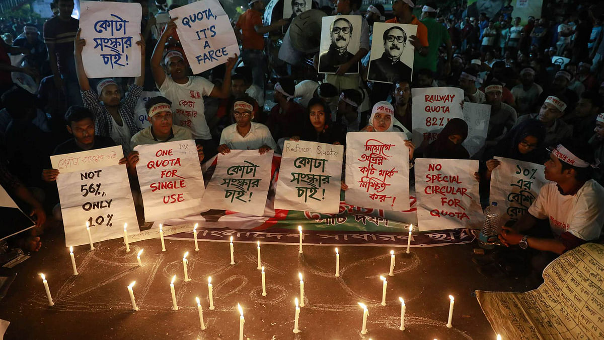 Demonstrators hold placards while protesting against existing quota system at night on 8 April. Photo: Suvra Kanti Das