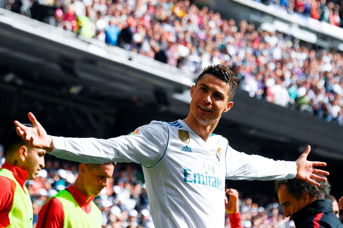Real Madrid’s Portuguese forward Cristiano Ronaldo celebrates after scoring a goal during the Spanish league football match between Real Madrid CF and Club Atletico de Madrid at the Santiago Bernabeu stadium in Madrid on Sunday. Photo: AFP