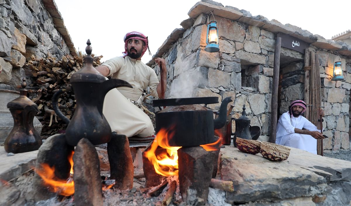An Emirati man makes traditional coffee during the Sharjah Heritage Days festival on 8 April 2018, at the Heritage Area in the United Arab Emirate. AFP
