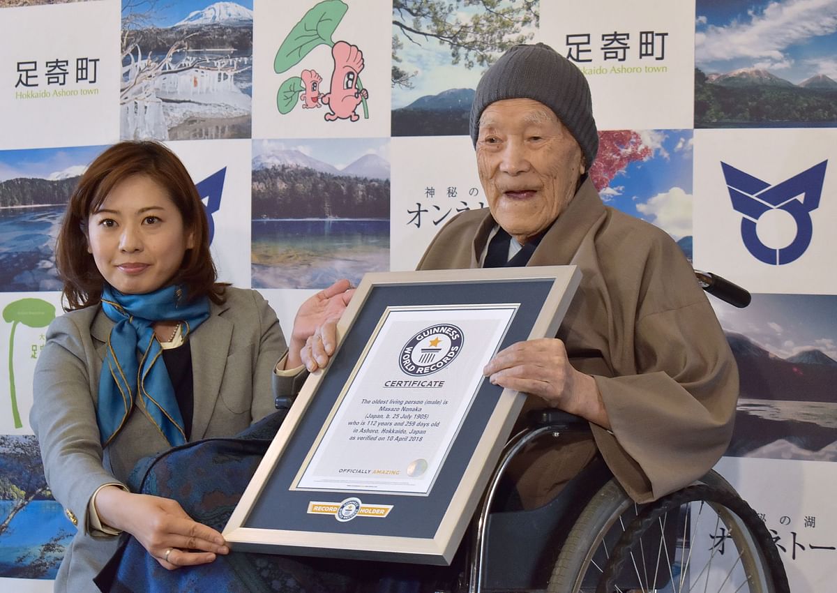 Masazo Nonaka of Japan (R), aged 112, receives a certificate for the Guinness World Records` oldest male person living title from Erika Ogawa (L), vice president of Guinness World Records Japan, in Ashoro, Hokkaido prefecture on April 10, 2018. Nonaka was born on July 25, 1905.