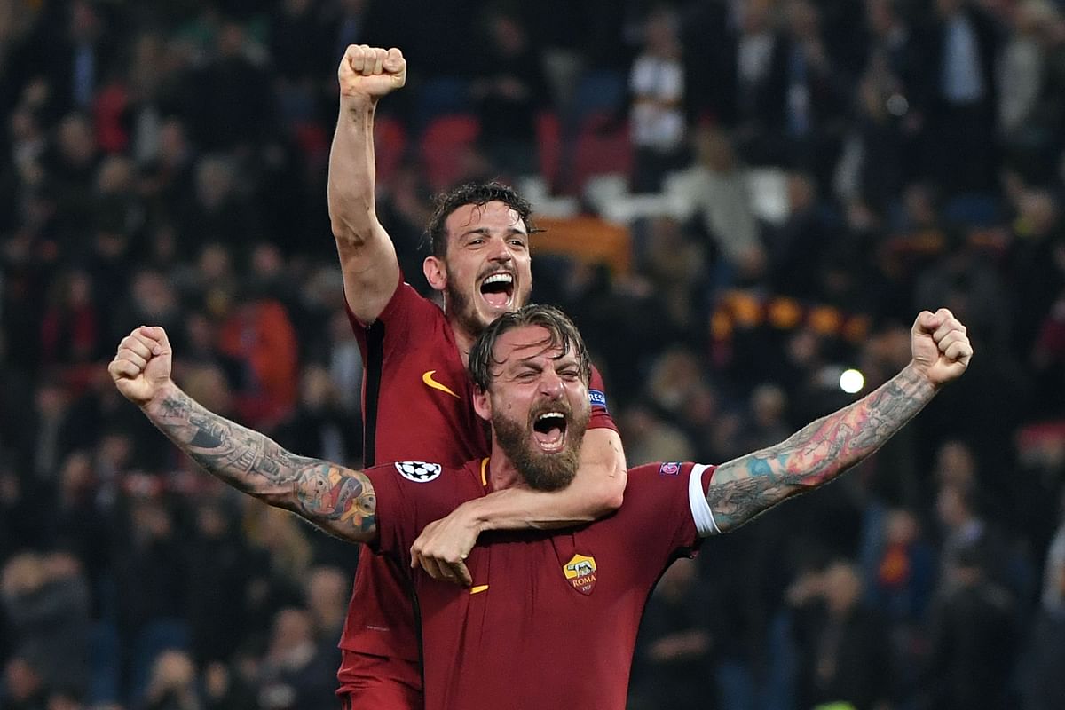 AS Roma’s players celebrate their victory at the end of the UEFA Champions League quarter-final second leg football match between AS Roma and FC Barcelona at the Olympic Stadium in Rome on Tuesday. Photo: AFP