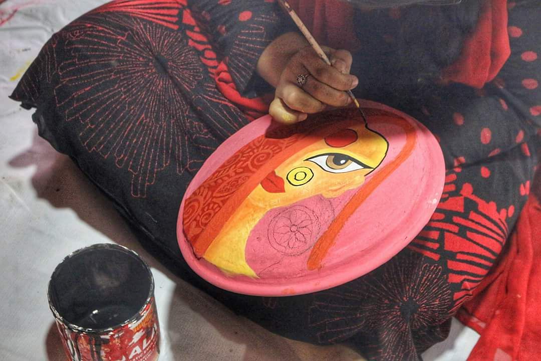 A student of East West University paints a clay pot to be used to decorate the campus on the Pahela Baishakh. Photo: Collected