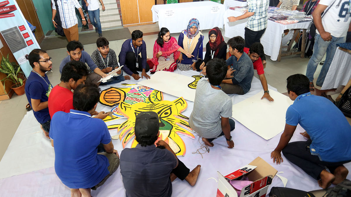 Students of Daffodil International University (DIU) prepare tiger masks and others motifs in preparation for the upcoming Pahela Baishakh to be celebrated on 14 April. Photo: Collected