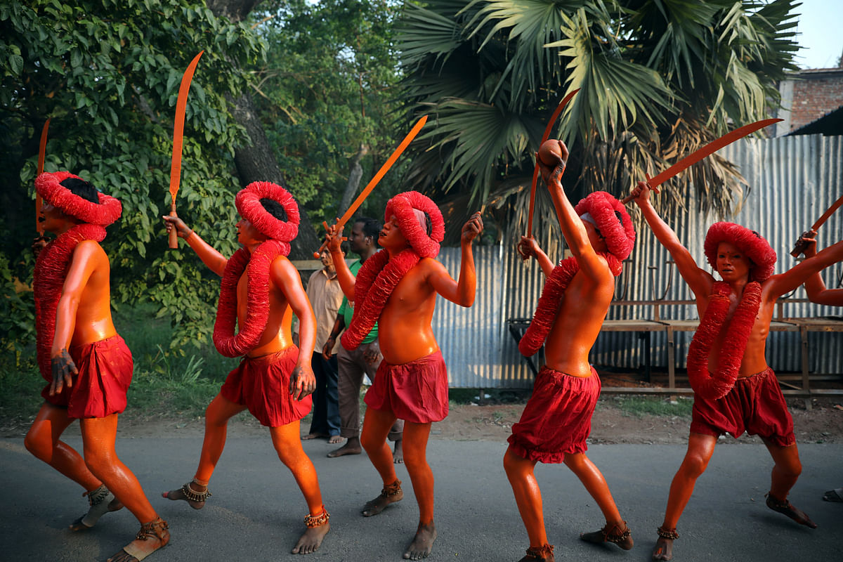 Hindu devotees dance on the street as they celebrate Lal Kach festival in Narayanganj. Reuters