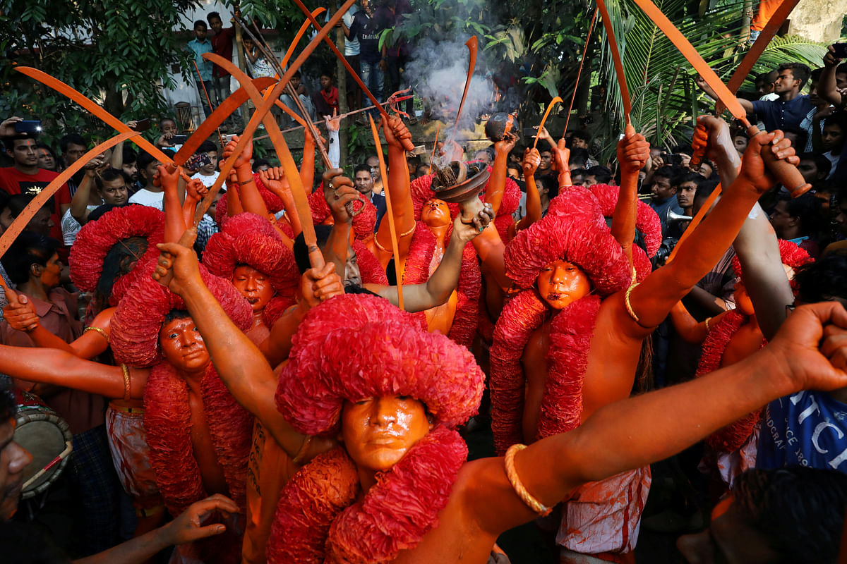 Hindu devotees dance on the street as they celebrate Lal Kach festival in Narayanganj. Reuters