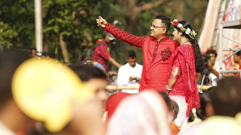A couple takes selfie during the Baishakh celebration at Shahbag area in Dhaka. Photo: Sumon Yusuf