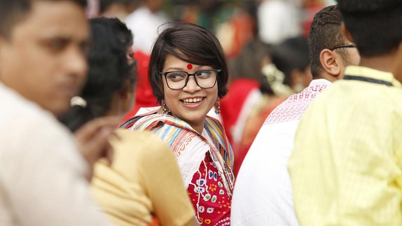 A young girl enjoys the Chhayanaut students performance at the Ramna Batamul area in Dhaka on Pahela Baishakh (1st day of Bangla New Year), 14 April. Photo: Sumon Yusuf