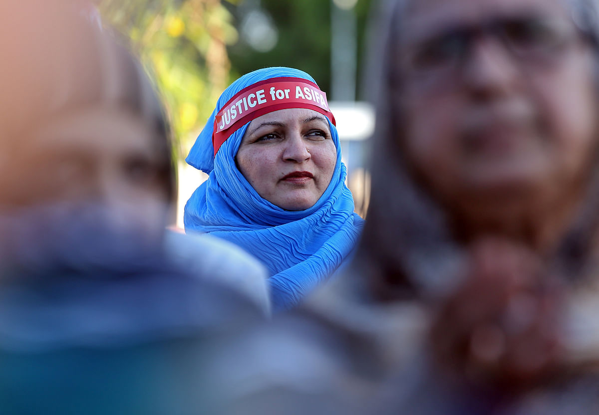 A woman wearing a headband attends a protest against the rape of an eight-year-old girl in Kathua, near Jammu, and a teenager in Unnao, Uttar Pradesh state, in Chennai, India on 14 April. Photo: Reuters