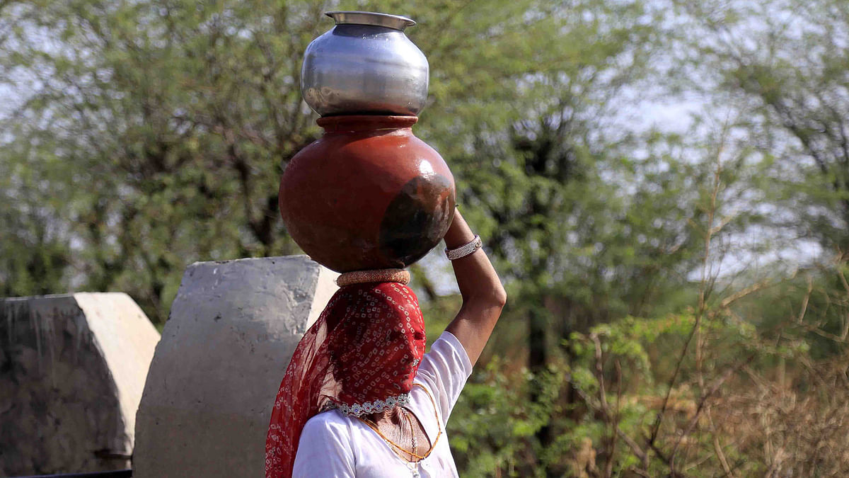 An Indian woman collects drinking water from a roadside water pump on the outskirts of Ajmer, in the Indian state of Rajasthan, on 14 April. Photo: AFP