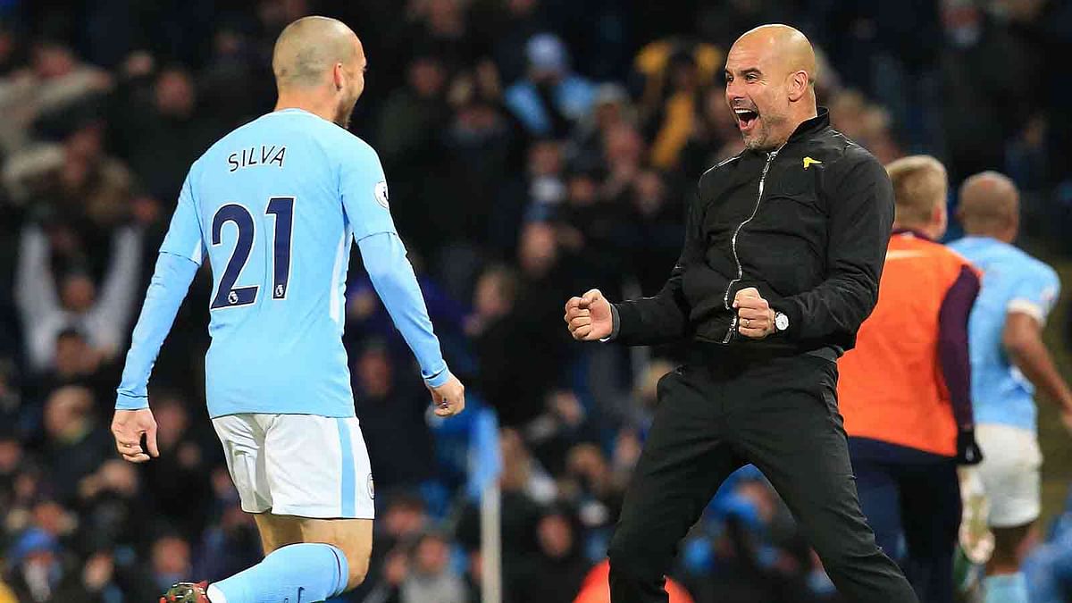 Manchester City’s Spanish manager Pep Guardiola celebrates with Manchester City’s Spanish midfielder David Silva after Manchester City’s English midfielder Raheem Sterling scores his team’s second goal during the English Premier League football match between Manchester City and Southampton at the Etihad Stadium in Manchester, north west England. AFP file photo
