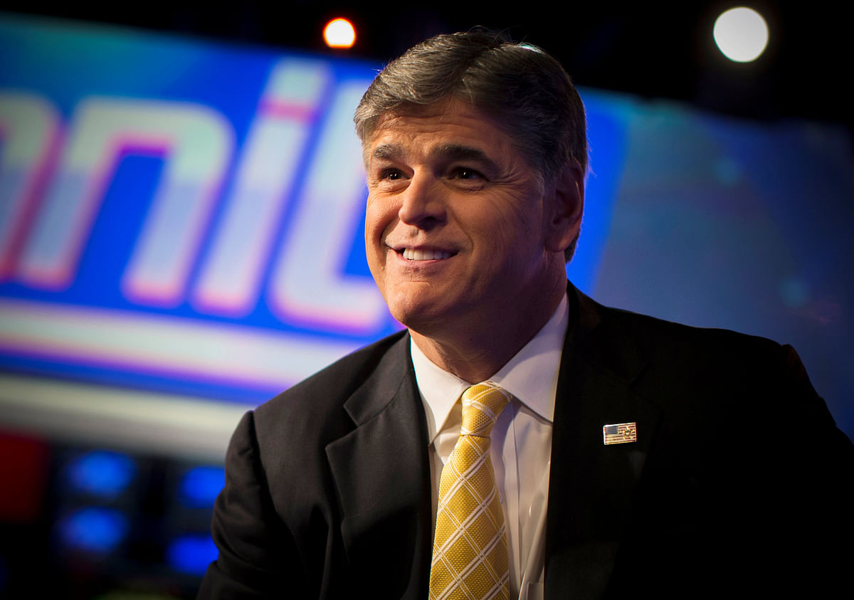 Fox News Channel anchor Sean Hannity poses for photographs as he sits on the set of his show “Hannity” at the Fox News Channel’s headquarters in New York City. Photo: Reuters