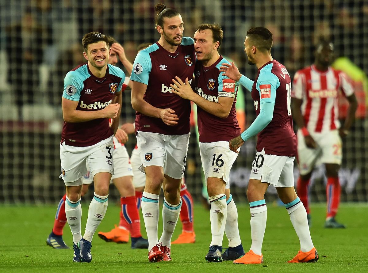 West Ham United’s English striker Andy Carroll (2L) celebrates scoring his team’s first goal with West Ham United’s English defender Aaron Cresswell (L) during the English Premier League football match between West Ham United and Stoke City at The London Stadium, in east London on Monday. Photo: AFP
