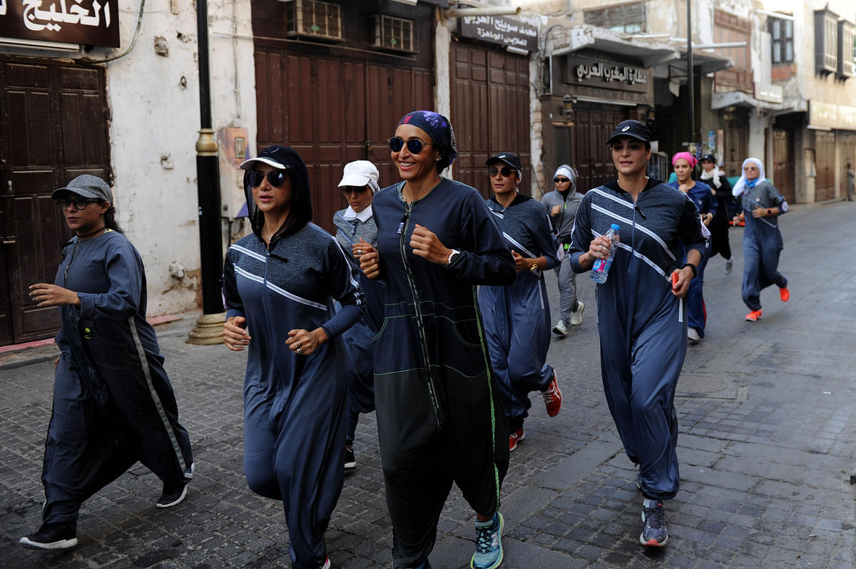 Saudi women jog in the streets of Jeddah`s historic al-Balad district on 8 March. Photo:AFP