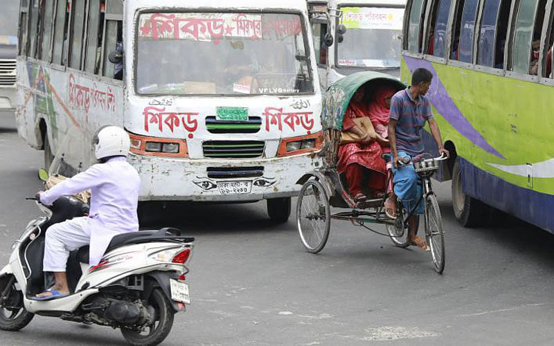 A rickshaw goes through the VIP road Shahbagh intersection.