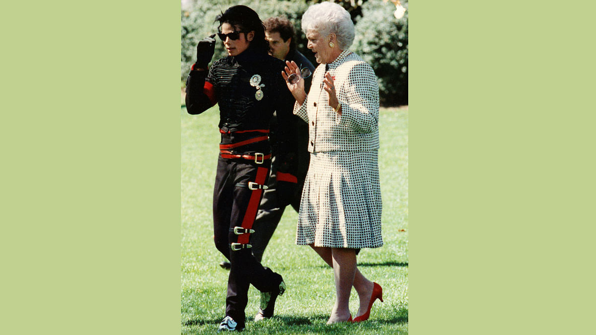 Michael Jackson (L) and former US First Lady Barbara Bush walk near the Rose Garden at the White House in Washington in the 1980s. Reuters