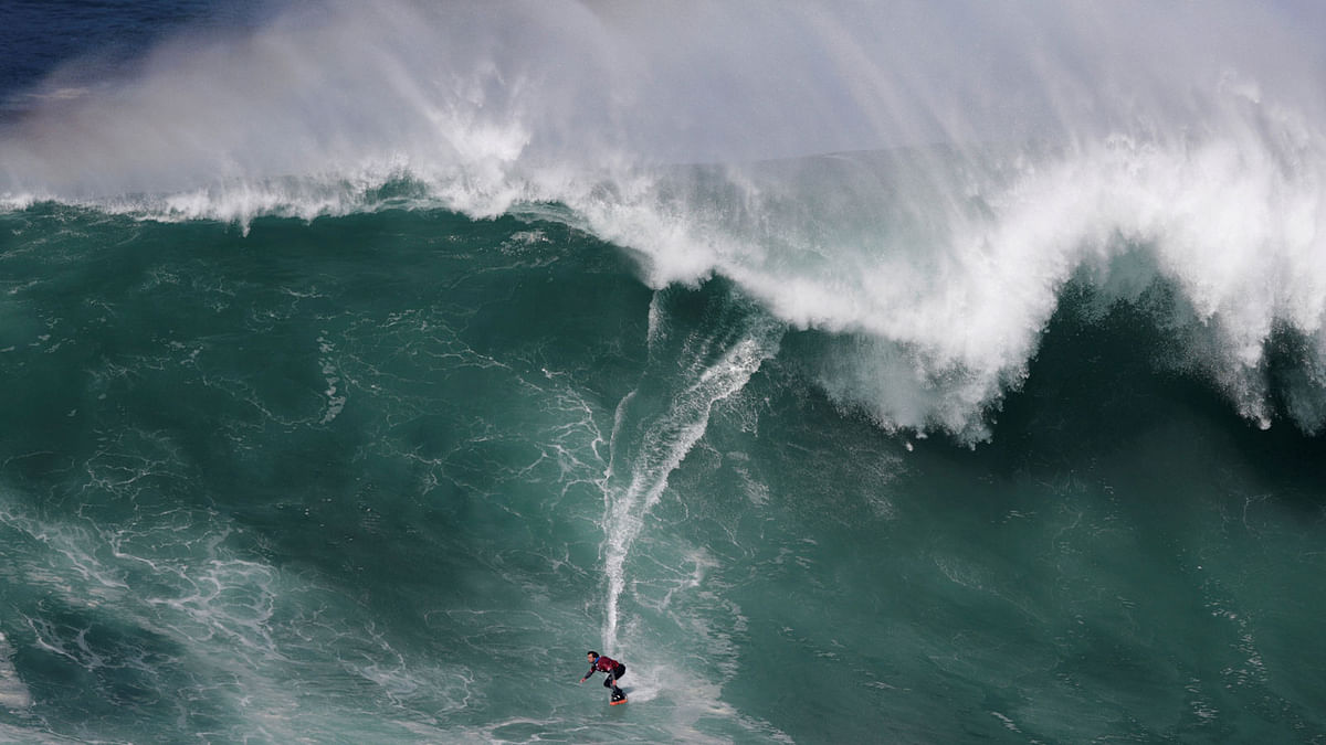 Spanish big wave surfer Axi Muniain drops in on a large wave at Praia do Norte in Nazare, Portugal on 18 April. Photo: Reuters