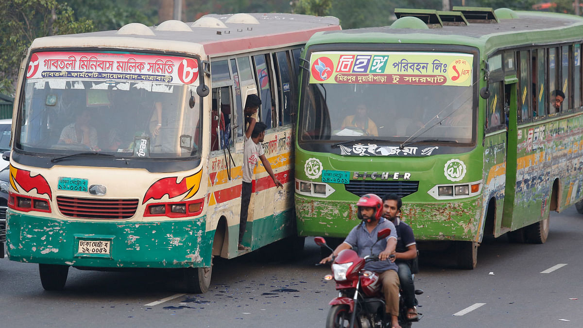 Two busses try to overtake each other. Such reckless driving often causes fatal road accidents. This photo is taken from the Karwan Bazar area of Dhaka on 19 April. Photo: Hassan Raza