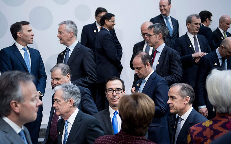 US Secretary of the Treasury Steven Mnuchin stands with others after a group photo of G-20 Finance Ministers and Central Bank Governors at the 2018 IMF/World Bank spring meetings on 20 April. Photo: AFP