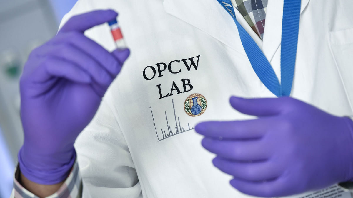 A laboratory technician controls a test vial at the OPCW (The Organisation for the Prohibition of Chemical Weapons) headquarters in the Hague, The Netherlands, on 20 April. Photo: AFP