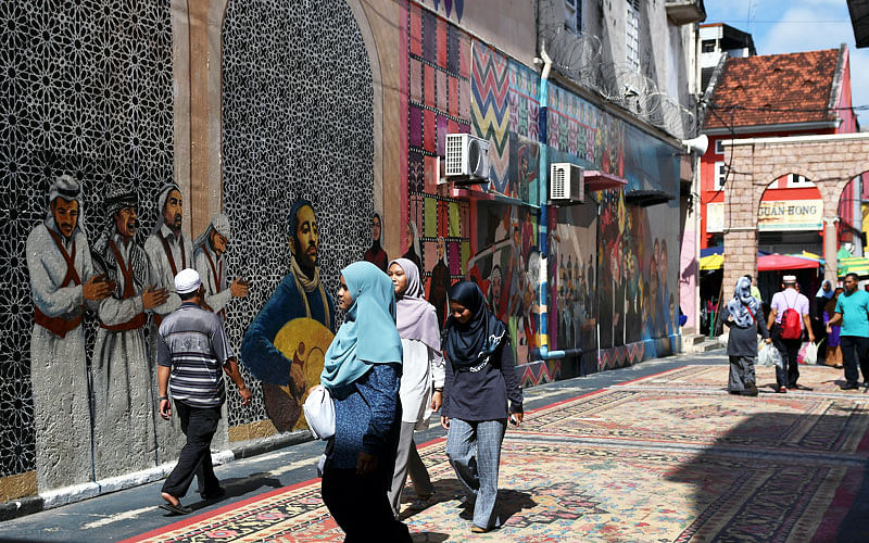 Pedestrians pass by a mural depicting Arab culture at Medan Ilmu in Kota Bharu, Kelantan, Malaysia. Reuters file photo