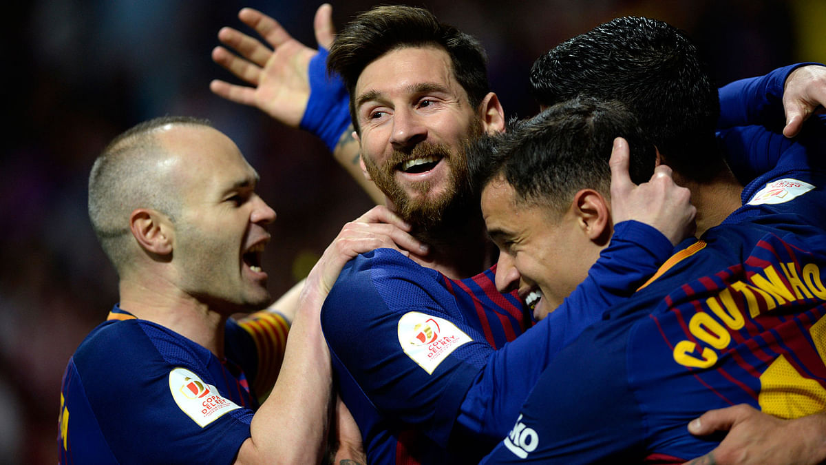 Barcelona’s Uruguayan forward Luis Suarez ® celebrates with Barcelona’s Spanish midfielder Andres Iniesta, Barcelona’s Argentinian forward Lionel Messi and Barcelona’s Brazilian midfielder Philippe Coutinho after scoring during the Spanish Copa del Rey (King’s Cup) final football match Sevilla FC against FC Barcelona at the Wanda Metropolitano stadium in Madrid on Saturday. Photo: AFP