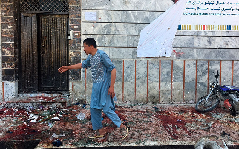 An Afghan man walks outside a voter registration center, which was attacked by a suicide bomber on 22 April. Photo: AP