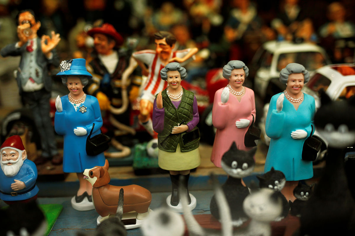 Figurines depicting Britain`s Queen Elizabeth II are displayed for sale in a souvenir shop, during the day of her 92nd birthday, in Ronda, southern Spain on 22 April. Reuters
