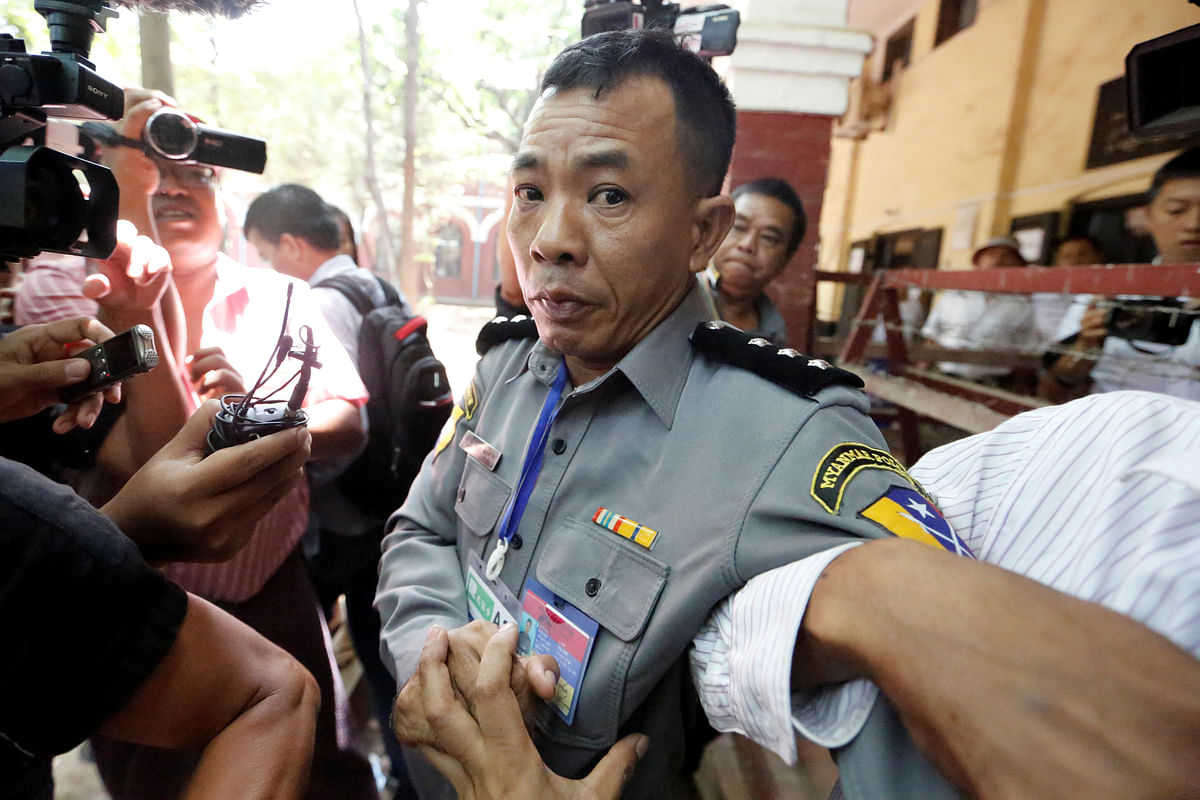 Prosecution witness police captain Moe Yan Naing walks outside the court room during a hearing of detained Reuters journalists Wa Lone and Kyaw Soe Oo in Yangon, Myanmar 20 April, 2018. Photo: Reuters