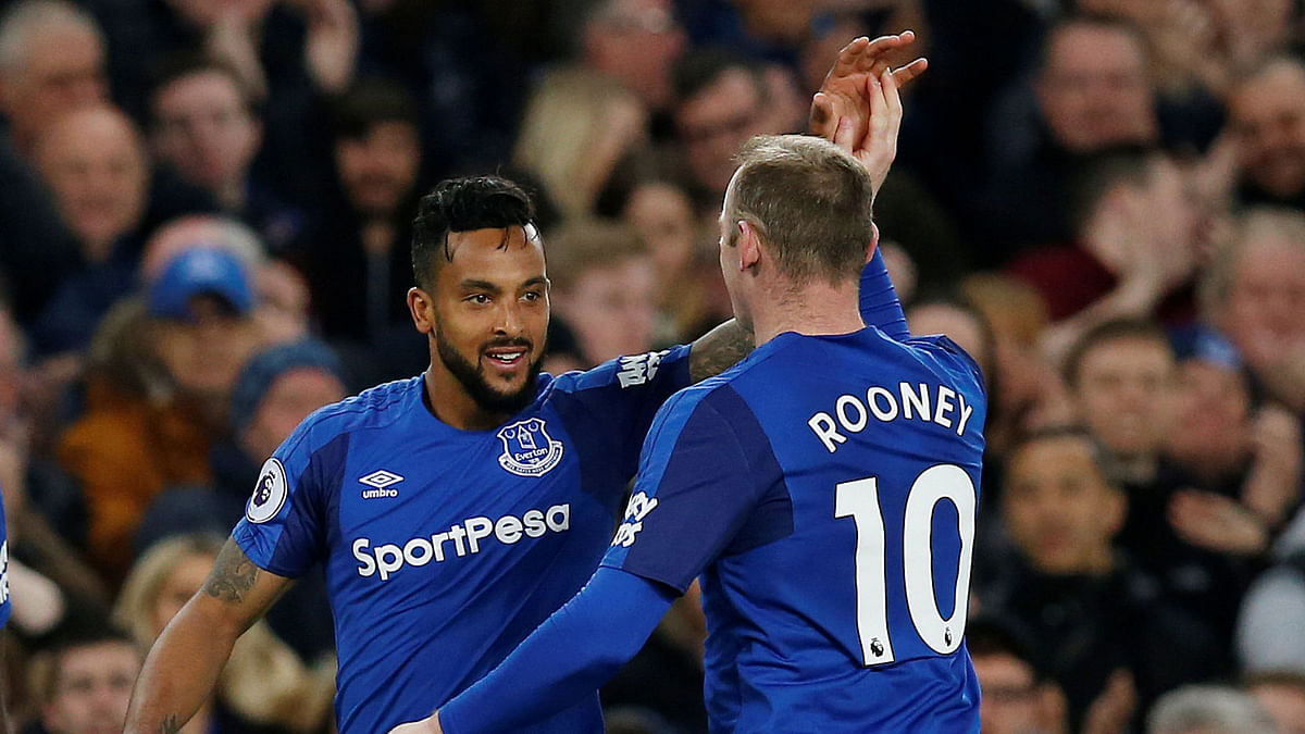 Everton’s Theo Walcott celebrates scoring their first goal with Wayne Rooney against Newcastle United in English Premier League at Goodison Park, Liverpool, Britain on Monday. Photo: Reuters