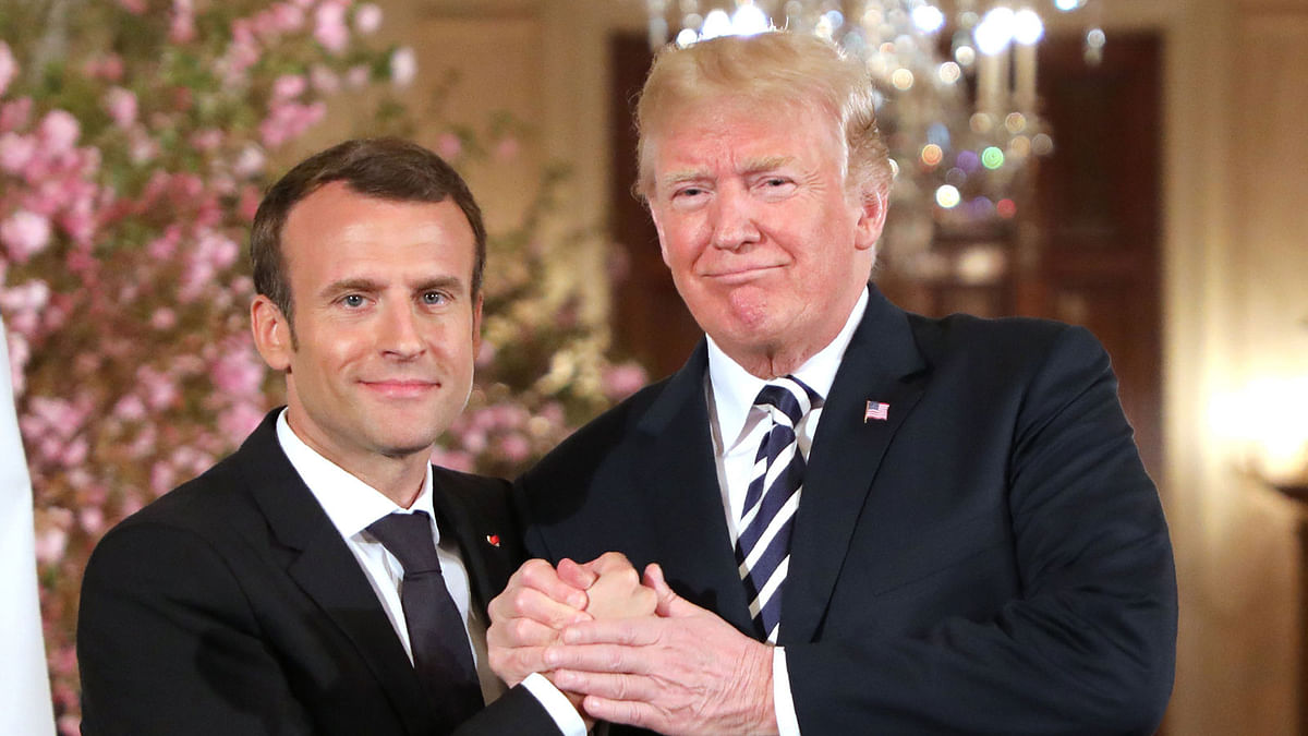 US President Donald Trump and French President Emmanuel Macron skahe hands during a joint press conference at the White House in Washington, DC, on Tuesday. Photo: AFP