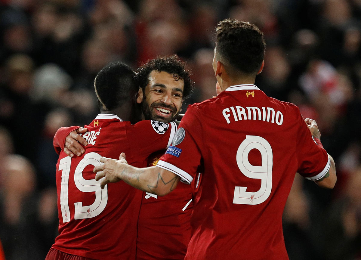 Liverpool’s Sadio Mane celebrates scoring their third goal with Mohamed Salah and Roberto Firmino in Champions League Semi Final First Leg match between Liverpool and AS Roma at Anfield, Liverpool, Britain on Tuesday. Photo: Reuters