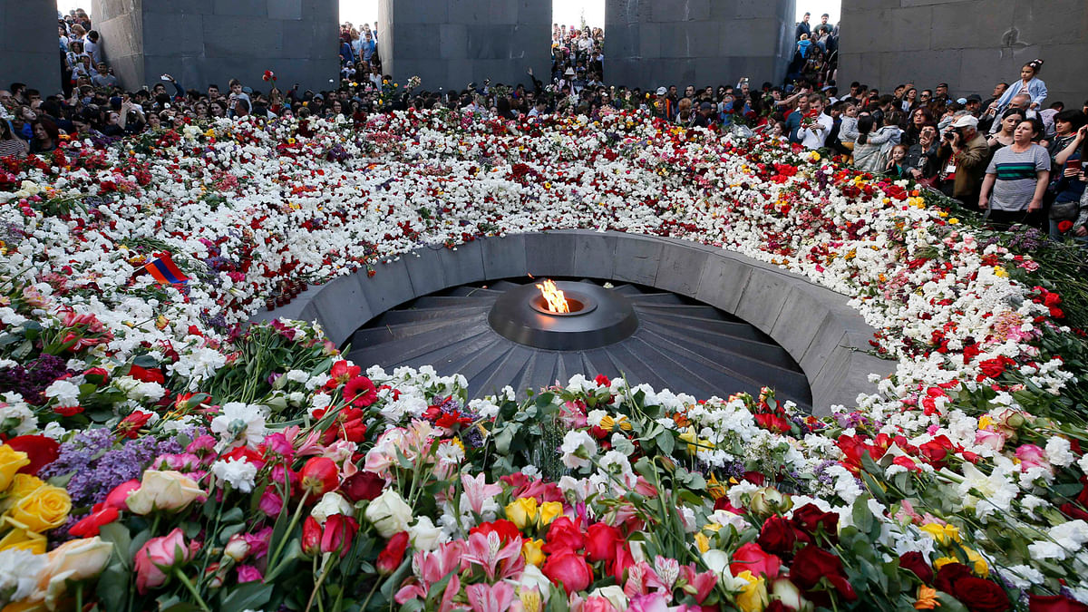 People lay flowers to commemorate the 103rd anniversary of mass killing of Armenians by Ottoman Turks, at the Tsitsernakaberd Memorial Complex in Yerevan, Armenia on 24  April. Photo: Reuters