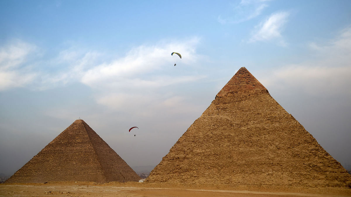 Paramotor pilots fly during an Air show above the great pyramids in Cairo on 28 April. Photo: AFP