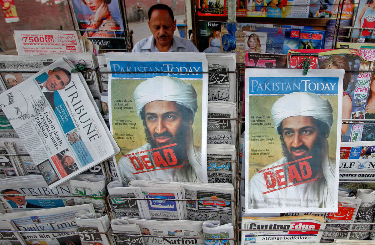 A roadside vendor sells newspapers with headlines about the death of al-Qaeda leader Osama bin Laden, in Lahore. Reuters file photo