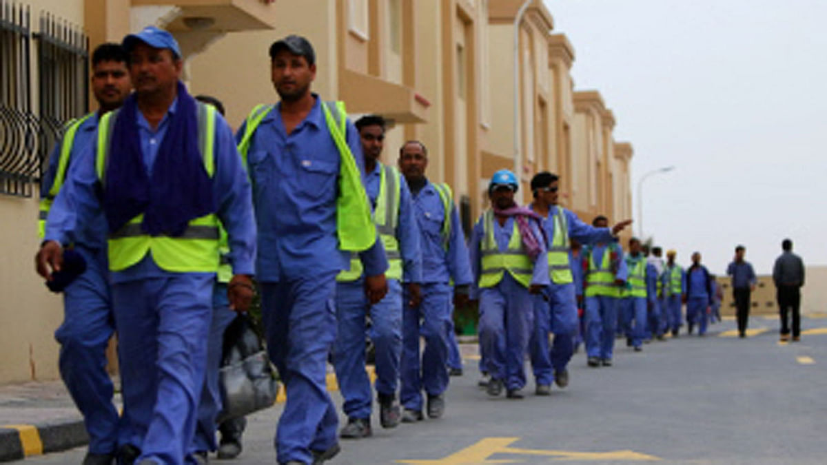 In this file photo taken on May 04, 2015 foreign workers on the construction site of the al-Wakrah football stadium, one of the Qatar`s 2022 World Cup stadiums, walk back to their accomodation at the Ezdan 40 compound after finishing work, in Doha`s Al-Wakrah southern suburbs. Photo : AFP